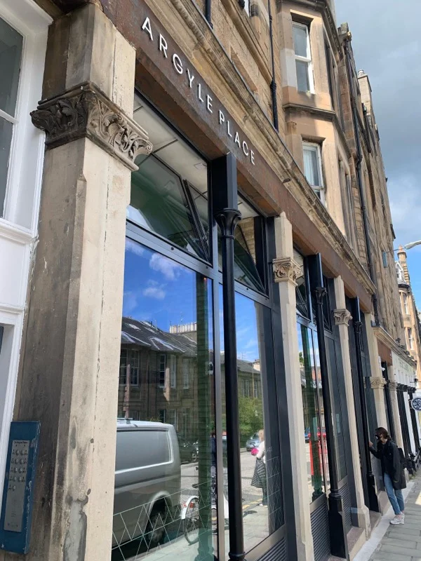 front view of Argyle place cafe with large floor to ceiling windows in an old tenement building 