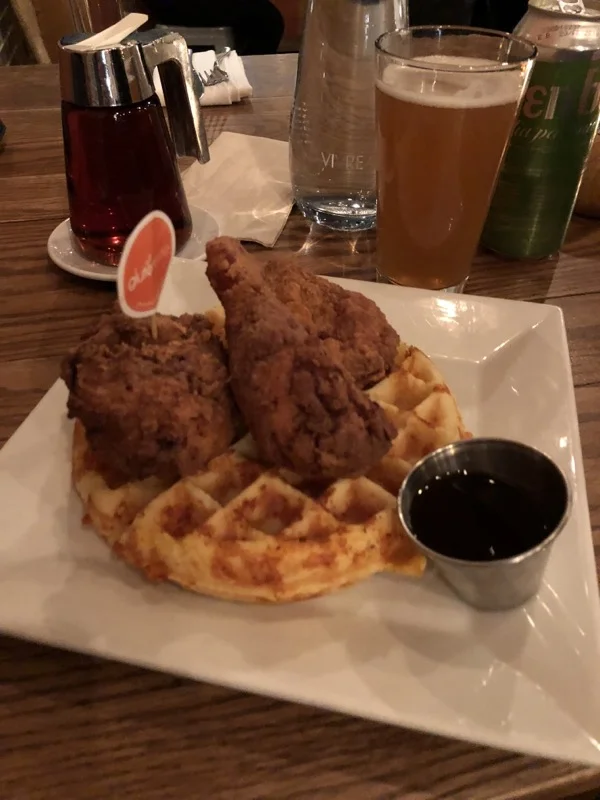 Fried chicken on waffle on white plate