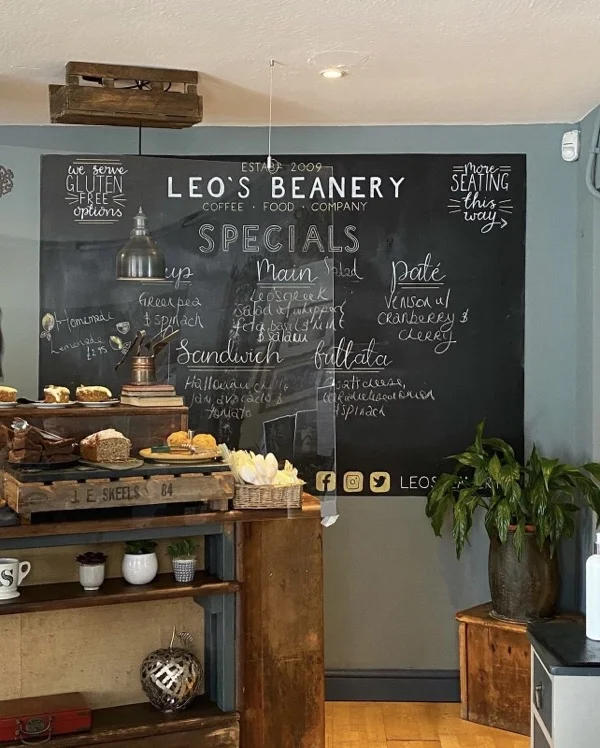 Blackboard with menu in chalk behind counter in cafe
