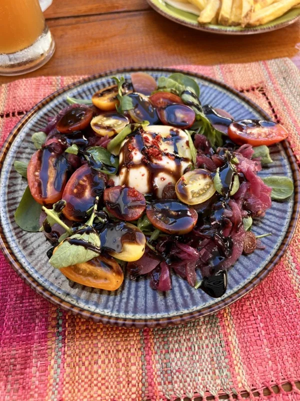 burrata salad on blue plate
