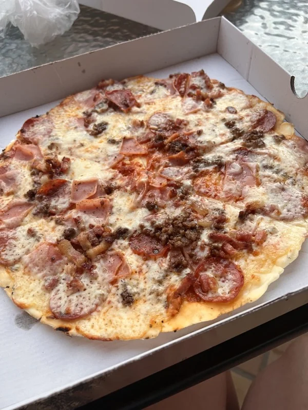 Meat feast gluten free pizza in takeaway box